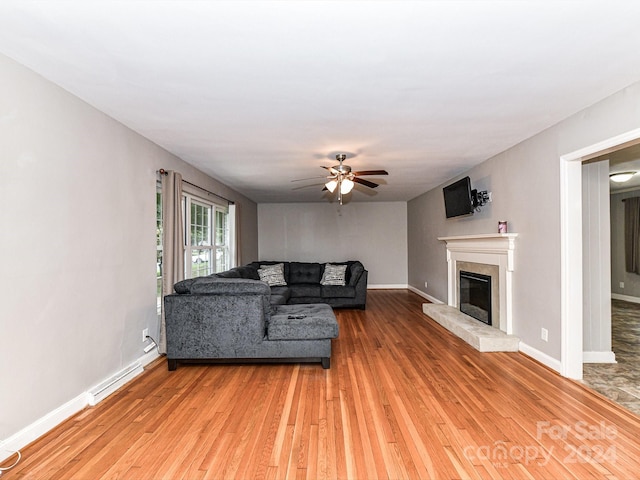 living room with ceiling fan and hardwood / wood-style floors