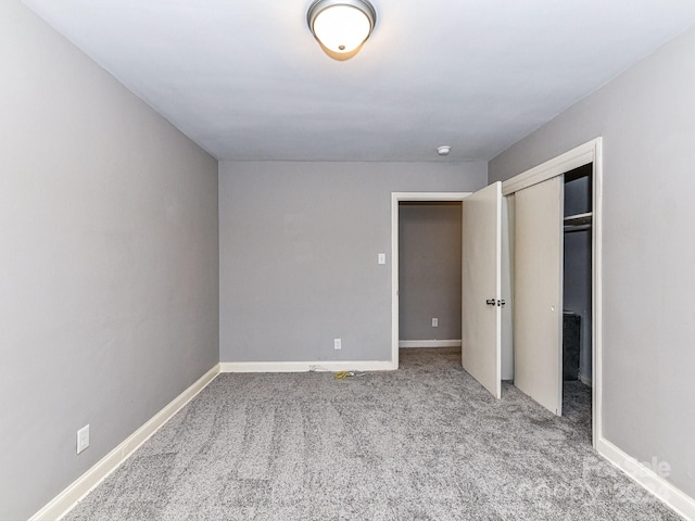 unfurnished bedroom with light carpet and a closet