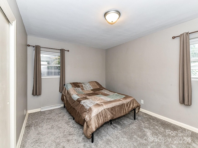 carpeted bedroom featuring a baseboard radiator