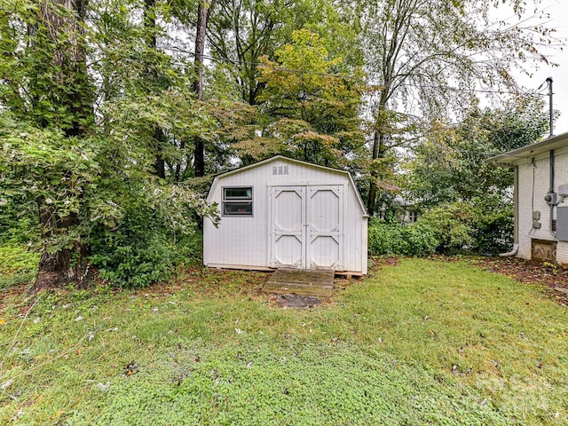 view of outbuilding with a yard