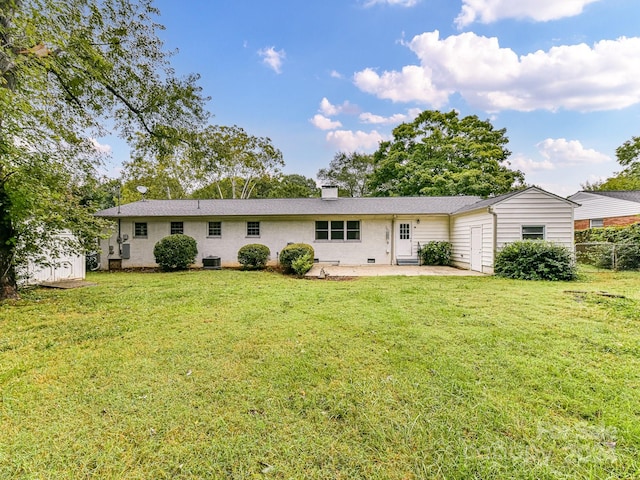 view of front of house featuring a front lawn, a patio, and central air condition unit