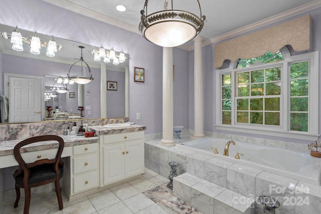 bathroom with tiled tub, vanity, crown molding, and decorative columns