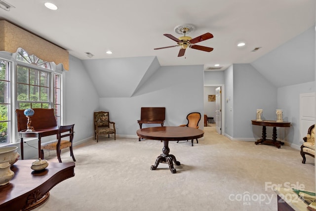 living area with ceiling fan, light colored carpet, and lofted ceiling