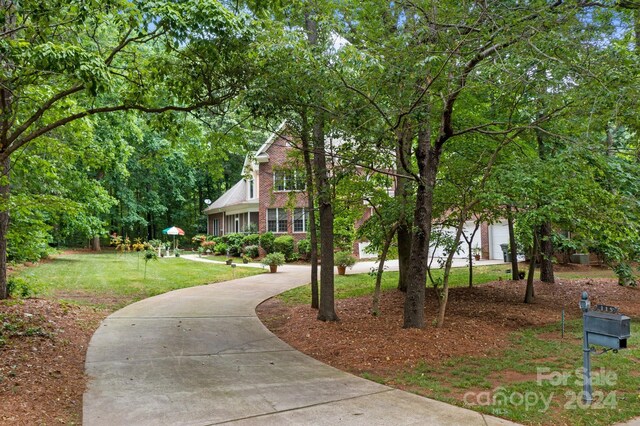 view of home's community featuring a garage and a yard