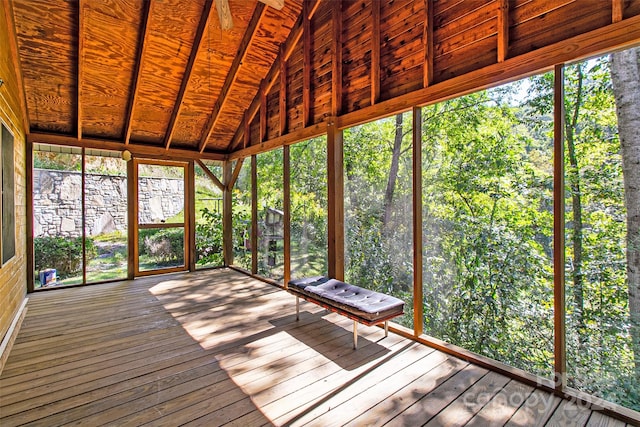 unfurnished sunroom featuring vaulted ceiling