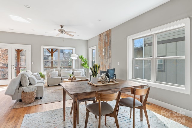 dining room with light wood-type flooring and ceiling fan