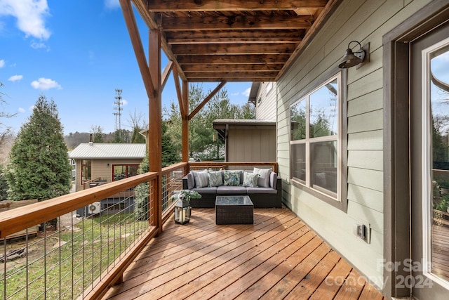 wooden terrace featuring an outdoor hangout area