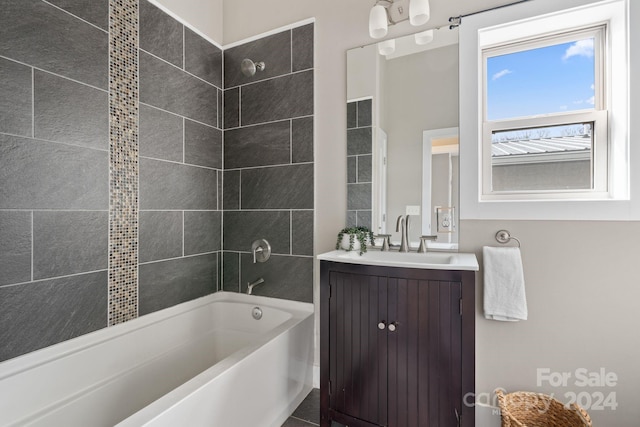 bathroom featuring vanity and tiled shower / bath combo