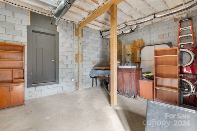 basement with stacked washer / drying machine