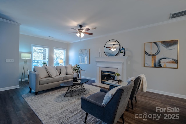 living room featuring crown molding, ceiling fan, and dark hardwood / wood-style floors