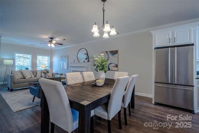 dining space featuring dark hardwood / wood-style flooring, ceiling fan with notable chandelier, and ornamental molding