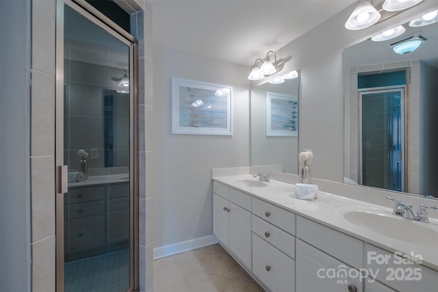 bathroom with vanity, a shower with shower door, and tile patterned floors