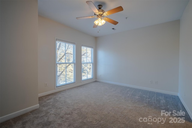 unfurnished room featuring ceiling fan and carpet floors