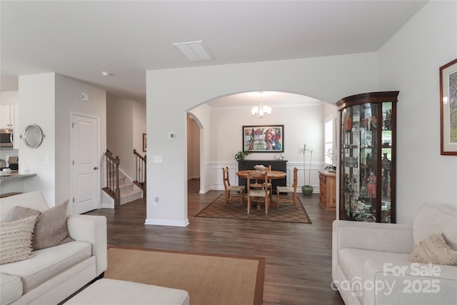 living room with dark hardwood / wood-style flooring and a chandelier