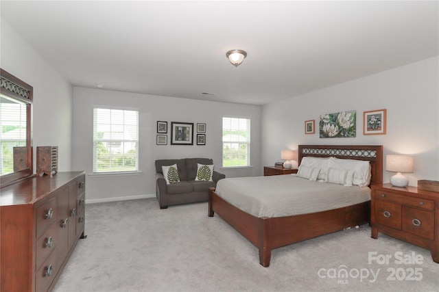 carpeted bedroom with multiple windows