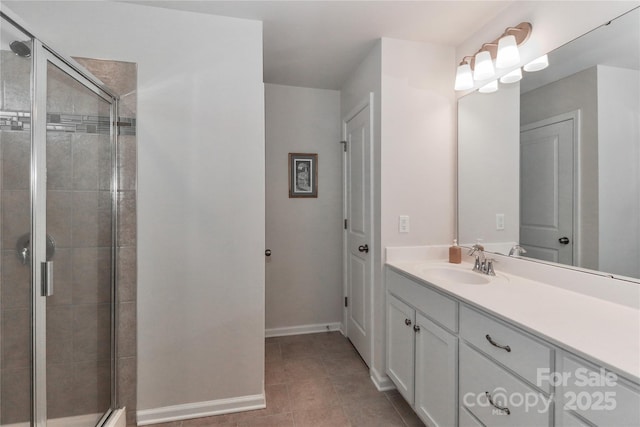 bathroom featuring an enclosed shower, vanity, and tile patterned flooring