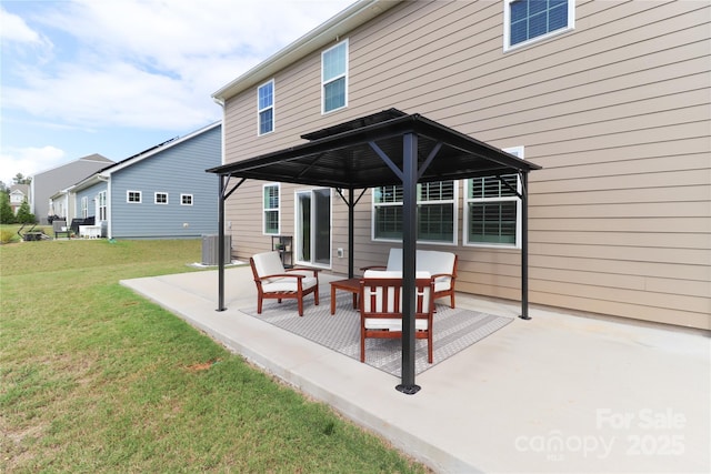 back of property featuring a patio area, a gazebo, central AC unit, and a yard