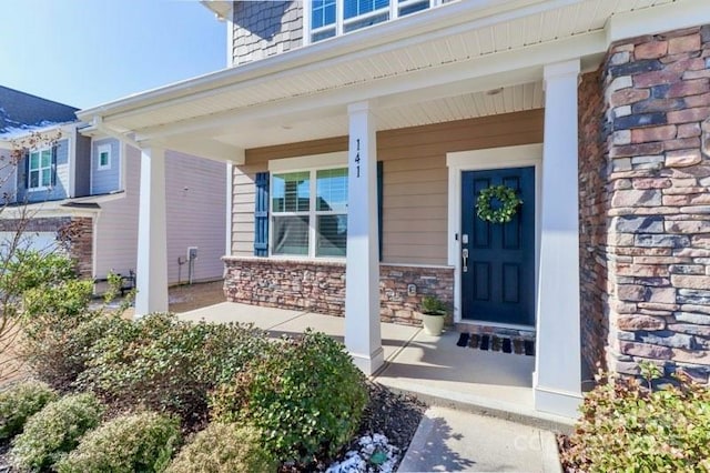 doorway to property featuring covered porch