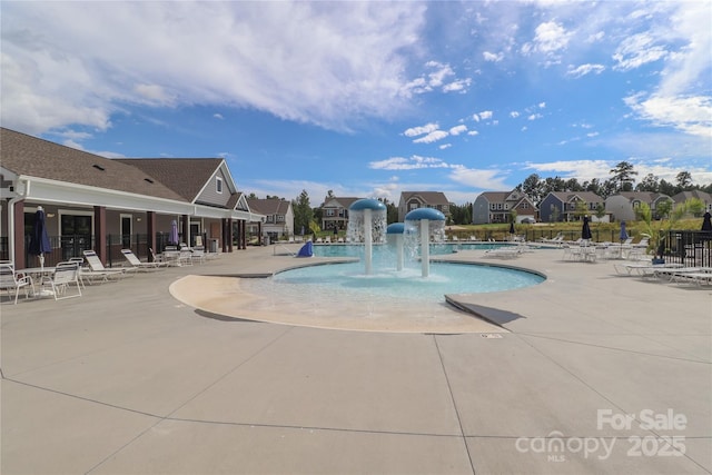 view of pool with pool water feature and a patio area