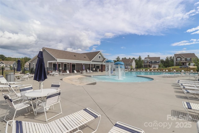 view of pool with pool water feature and a patio