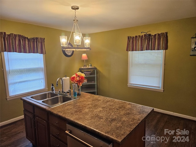 kitchen featuring an inviting chandelier, dishwasher, a center island with sink, and dark wood-type flooring