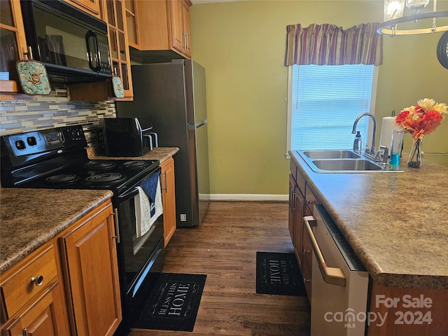 kitchen featuring sink, dark wood-type flooring, decorative backsplash, and black appliances