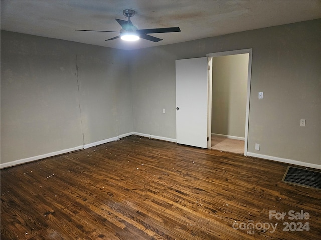 unfurnished room with dark hardwood / wood-style flooring and ceiling fan