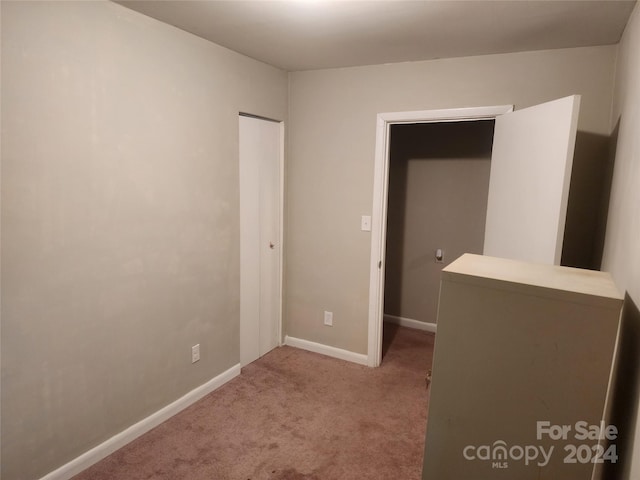 unfurnished bedroom with light carpet