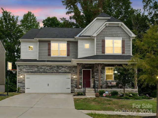 craftsman house with a porch and a garage