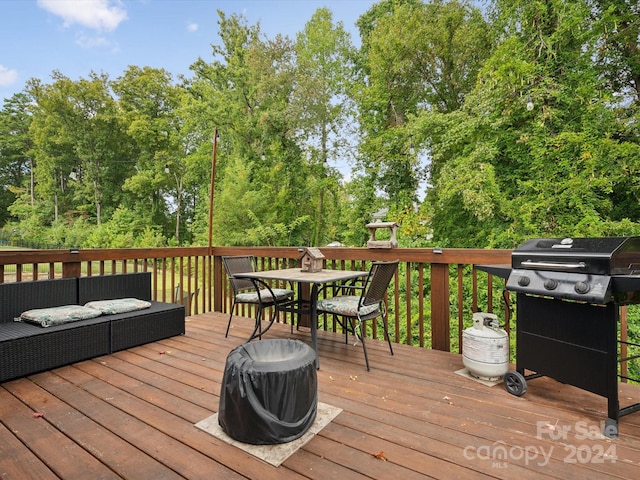 wooden terrace featuring a grill