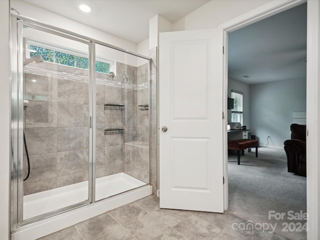 bathroom featuring a shower with shower door