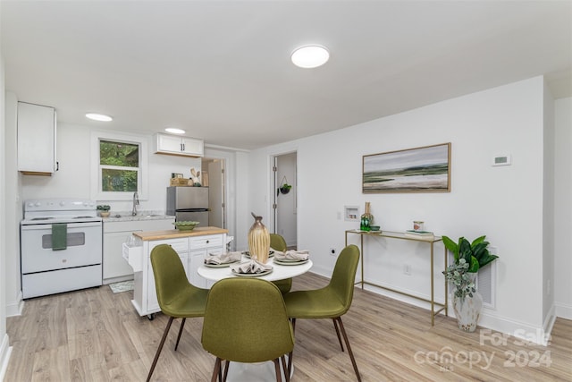 dining room featuring light wood-type flooring and sink