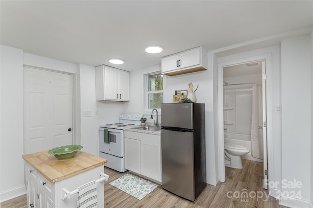 kitchen featuring light wood-type flooring, a center island, white cabinetry, white electric range oven, and stainless steel fridge