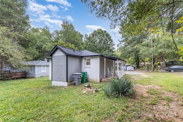 rear view of property featuring a yard