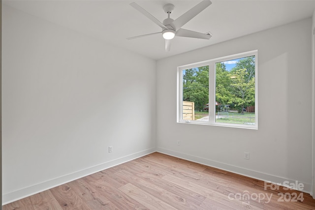 unfurnished room with light wood-type flooring and ceiling fan