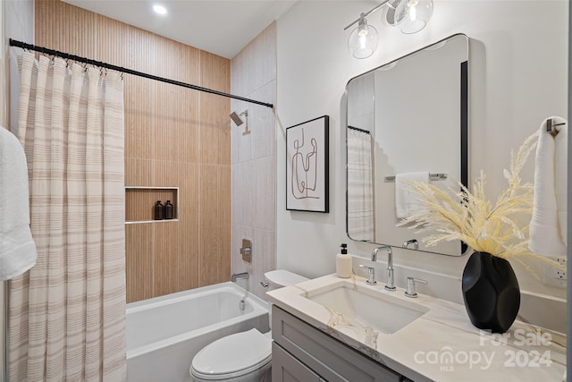 full bathroom featuring shower / bath combo with shower curtain, vanity, and toilet