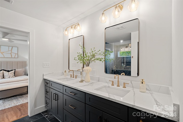 bathroom featuring vanity, ceiling fan, and wood-type flooring