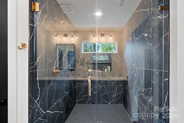 bathroom featuring tile walls and an enclosed shower