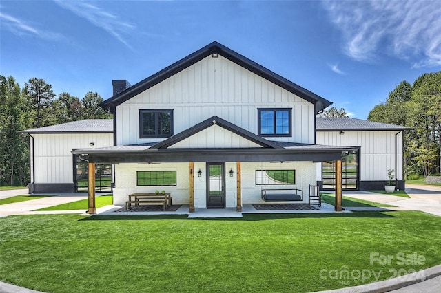 modern farmhouse with a porch and a front lawn