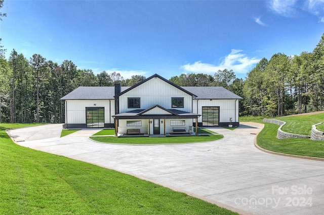 modern farmhouse style home with a front yard