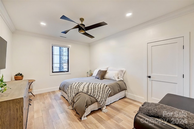 bedroom with ceiling fan, crown molding, and light hardwood / wood-style floors