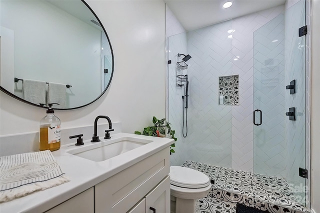 bathroom with vanity, toilet, and an enclosed shower