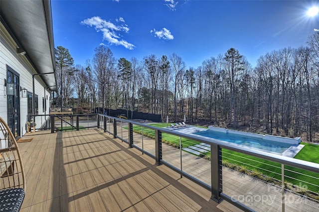 wooden terrace featuring a yard