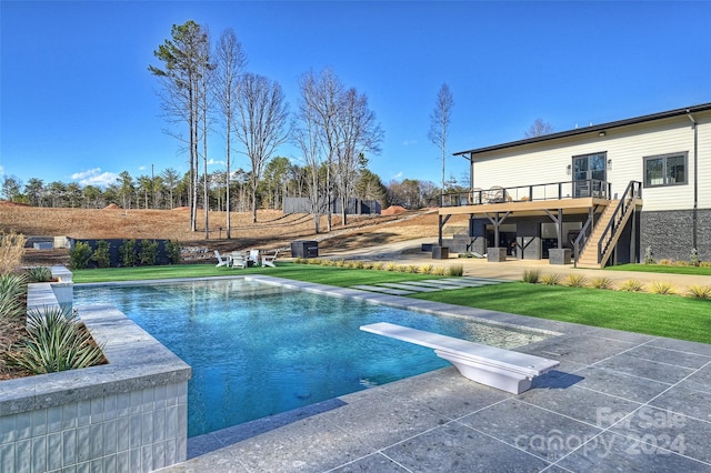 view of swimming pool with a deck and a yard