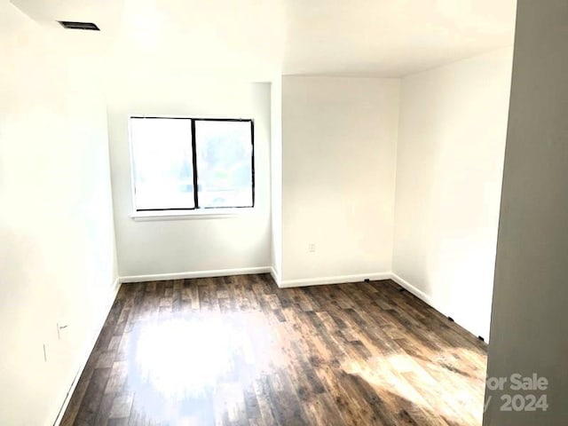 spare room featuring dark wood-type flooring