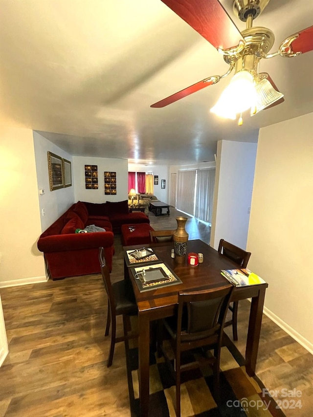 dining area featuring ceiling fan and dark wood-type flooring