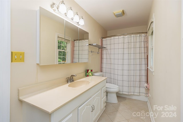 bathroom with vanity, tile patterned flooring, toilet, and curtained shower