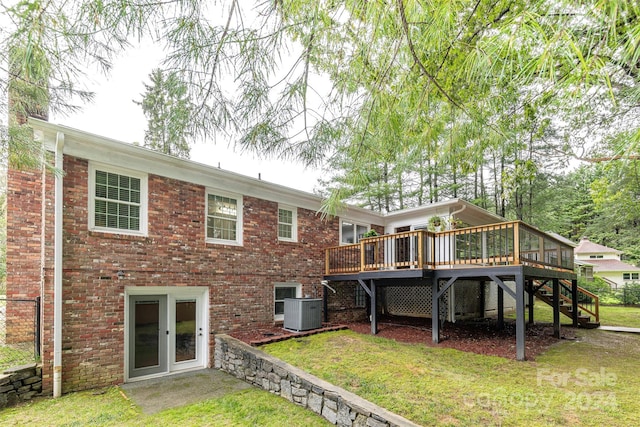 back of house with a wooden deck, french doors, central air condition unit, and a yard