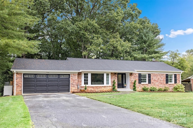 ranch-style house with a garage and a front lawn