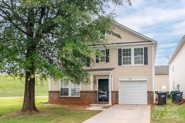 view of front facade with a front yard and a garage